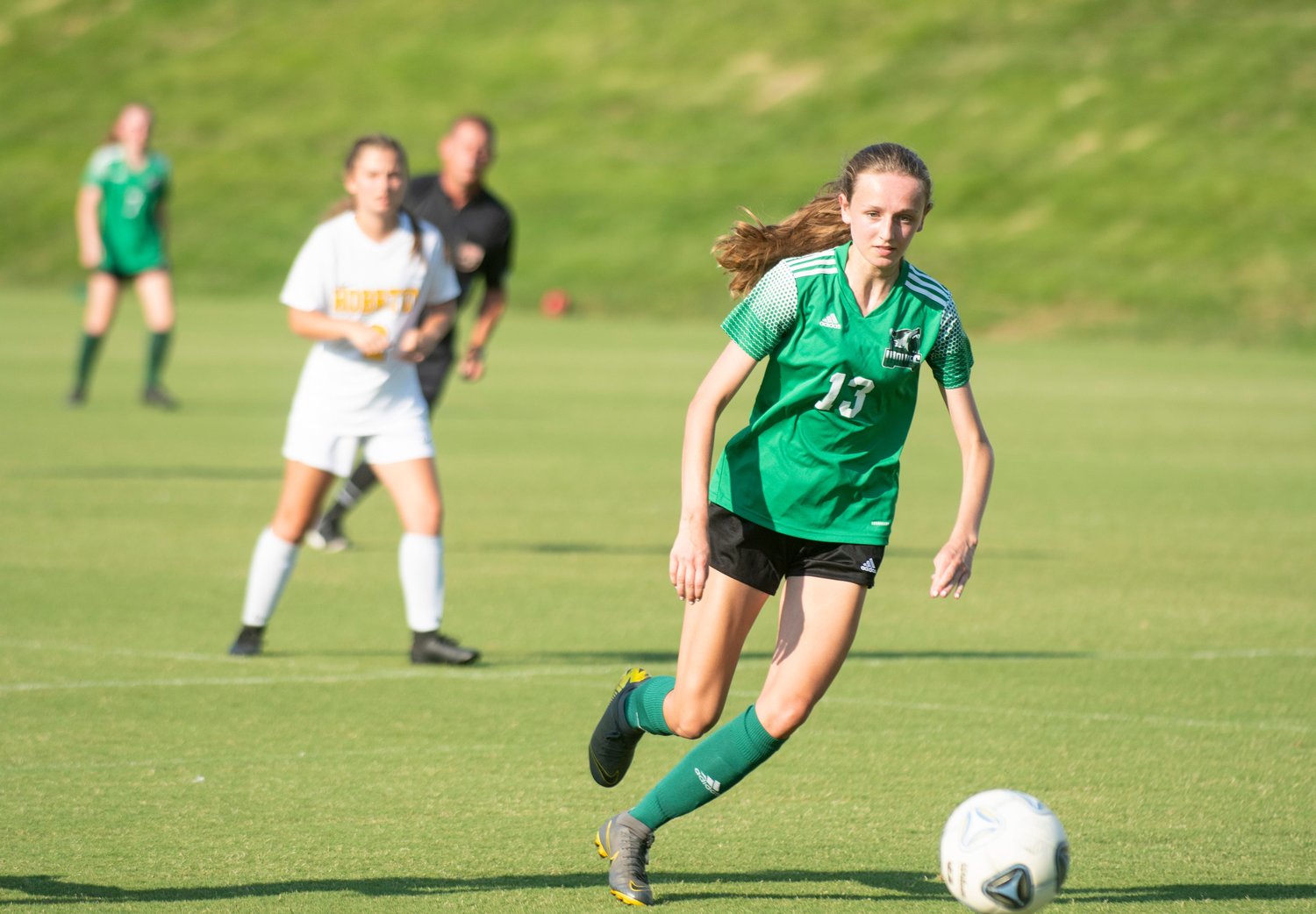 Woods Charter sophomore Caroline Mitchell (13) dribbles the ball downfield in the Wolves' 5-0 win over the Hobbton Wildcats last Tuesday in Cary.